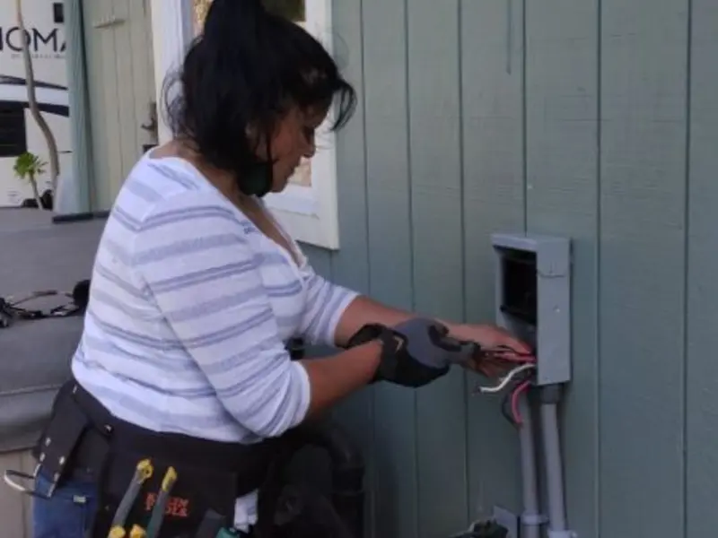 Licensed electrician wiring an exterior subpanel in Lindenhurst