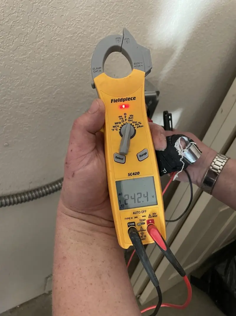 Voltage testing with clamp meter during Ceiling Fan Installation in Lindenhurst